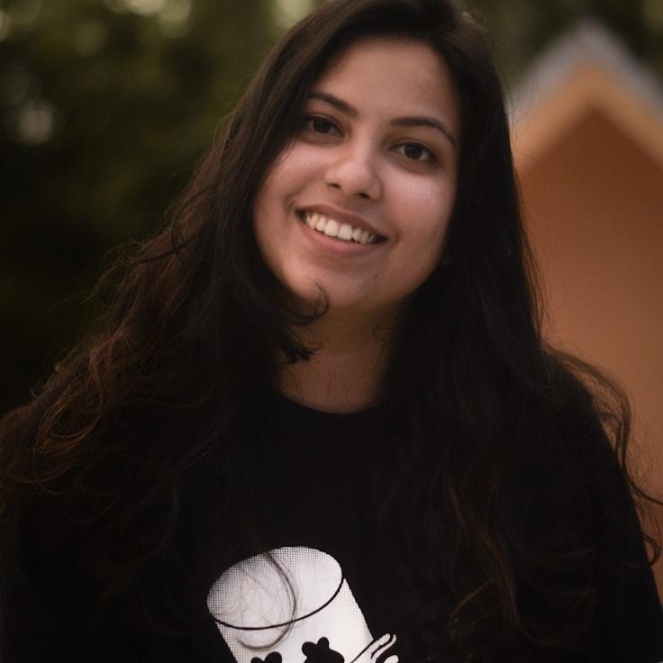 Alex Chen, Lead Design Curator at PebbleForestZen, reviewing corporate floral arrangements